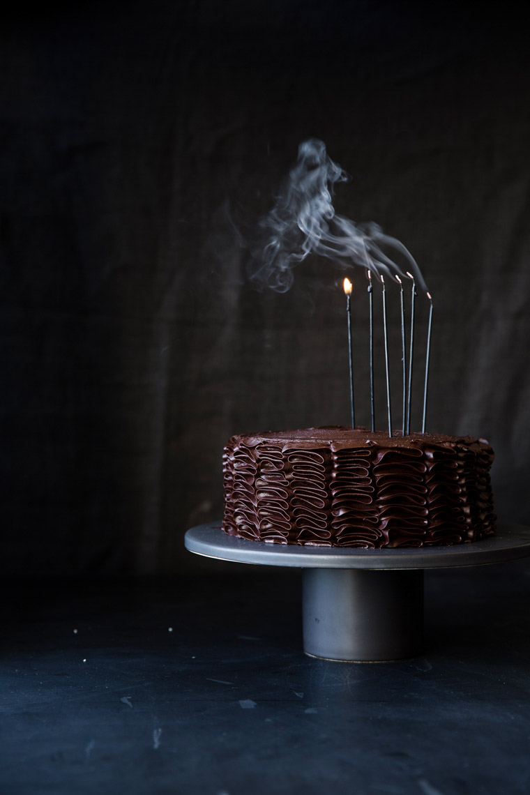 food stylist in San Francisco - Chocolate birthday layer cake with candles Let us All eat Cake cookbook - Catherine Ruehle author photographed by Erin Kunkel Photographer